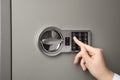 Woman opening steel safe with electronic lock