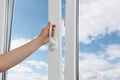 Woman opening white plastic window at home, closeup Royalty Free Stock Photo