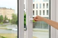 Woman opening white plastic window at home, closeup Royalty Free Stock Photo