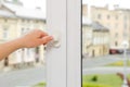 Woman opening white plastic window at home, closeup Royalty Free Stock Photo
