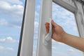 Woman opening white plastic window at home, low angle view Royalty Free Stock Photo