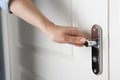Woman opening white wooden door, closeup Royalty Free Stock Photo