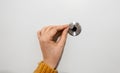 Woman opens the door peephole Royalty Free Stock Photo