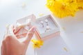 Woman opens a gift box with a set of pearl jewellery surrounded with flowers Royalty Free Stock Photo