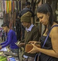 Woman opens her purse to pay the street vendor