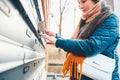 Senior woman opens the mailbox to check for new mails