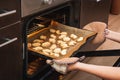 Woman opens the oven where cookies are baked for Halloween. Woman opens the oven where cookies are baked for Halloween Royalty Free Stock Photo