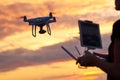 Drone quadcopter with digital camera flying at sunset Royalty Free Stock Photo