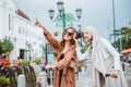 woman operating her camera beside the woman with long brown hair Royalty Free Stock Photo