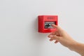 Woman using manual call point of fire alarm system Royalty Free Stock Photo