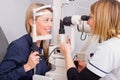 Woman in optometrists office checking her vision