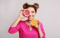 Woman with orange and grapefruit halves over background Royalty Free Stock Photo