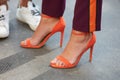 Woman with orange high heel open shoes and nail polish before Blumarine fashion show, Milan Fashion Week