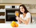 Woman orange juice morning kitchen Royalty Free Stock Photo