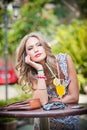 Woman with orange juice in outside bar Royalty Free Stock Photo