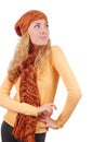 Woman in orange knitted hat, scar and sweater looking up