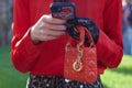 Woman with orange leather Dior bag and red shirt before Emporio Armani fashion show, Milan Royalty Free Stock Photo