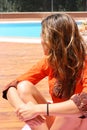 Woman in orange by the pool