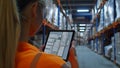 Woman in Orange Shirt Using Tablet