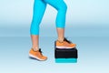 Woman do exercise on an aerobic and fitness step