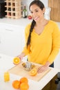 woman with orange squeezer and glass juice