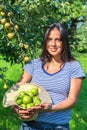 Woman in orchard holding hat filled with pears Royalty Free Stock Photo