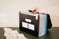 Woman Organizing Documents in a 12-Month Accordion File Organizer