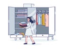 Woman organizing wardrobe packing or unpacking clothes before travel or moving to new home