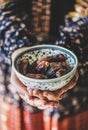 Woman holding bowl of dates for Ramazan Iftar fasting meal