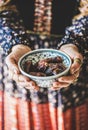 Woman in oriental dress holding bowl of dates for Ramazan