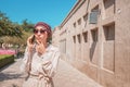 Woman in an oriental turban is talking on the phone with emotions of concern and anxiety. The concept of phone fraud and