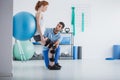 Woman with orthopedic problem exercising with ball Royalty Free Stock Photo