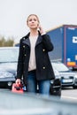Woman out of gas with her car phoning for somebody to pick her up Royalty Free Stock Photo