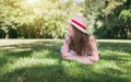 Woman outdoor portrait. Happy, young woman laying on green grass