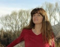 A Woman Outdoors Against a Fallen Tree