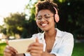 Woman outdoors in park listening music