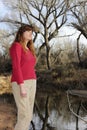 A Woman Outdoors on a River Bank Royalty Free Stock Photo