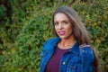 Woman outside jean jacket twenty year old brunette in nature outdoor portrait lipstick girl smiling