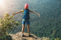 Woman outstretched arms on mountian top