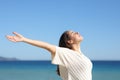 Woman outstretching arms and breathing on the beach Royalty Free Stock Photo