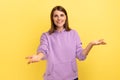 Woman outstretching hands looking at camera with kind smile, greeting and regaling.