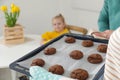 Woman with oven baked cookies and her family Royalty Free Stock Photo