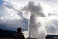 Woman overlooks Old Faithful Geyser