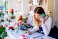 Woman owner of florist shop taking orders Royalty Free Stock Photo