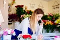 Woman owner of florist shop taking orders Royalty Free Stock Photo