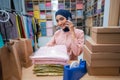 woman owner having a phone call while checking the product Royalty Free Stock Photo