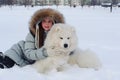 Woman owner hugging white Samoyed dog Royalty Free Stock Photo