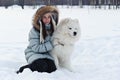 Woman owner hugging white Samoyed dog Royalty Free Stock Photo