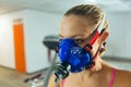 Woman with oxygen mask before exercise in fitness center