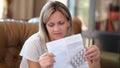 Woman with package of medical pills reads leaflet with instructions for taking pills.